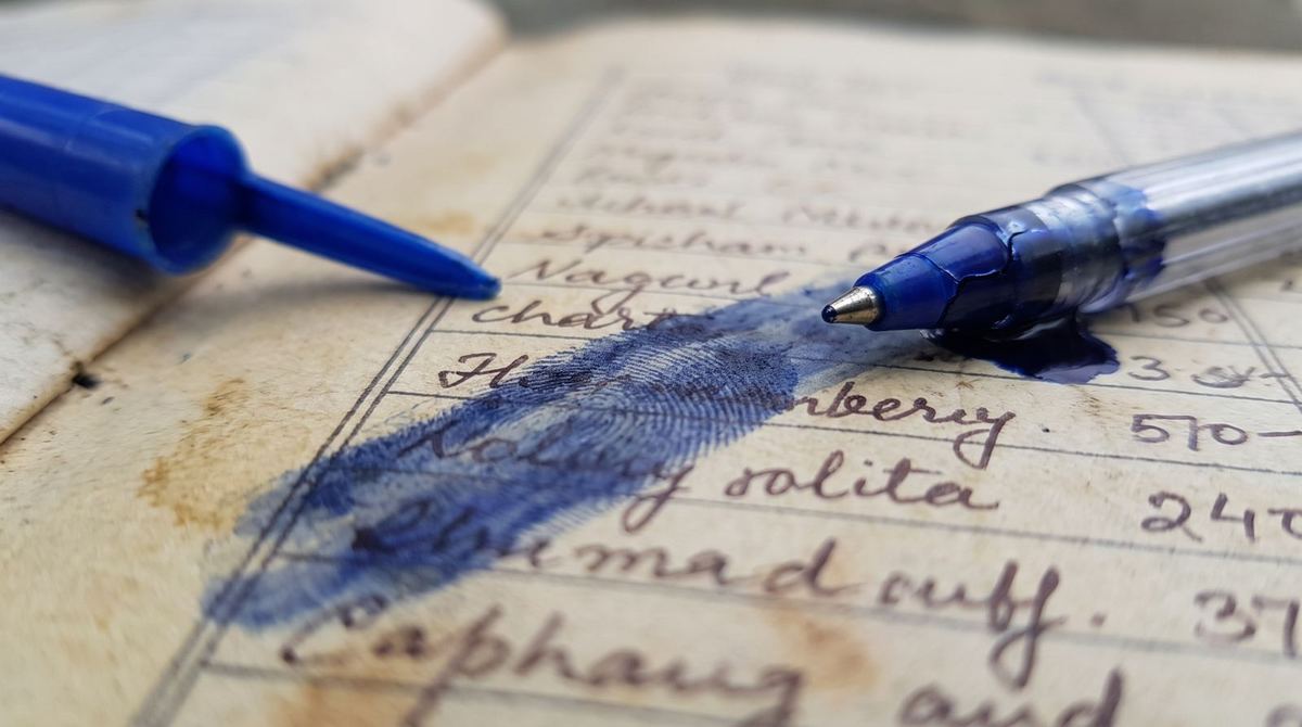 A leaking pen smudging an entry in a khata book